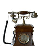 A vintage-style rotary telephone with a dark brown wooden base and brass/gold-toned metal components, shown on a plain white background.