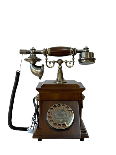 A vintage-style rotary telephone with a dark brown wooden base and brass/gold-toned metal components, shown on a plain white background.