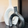 Two unique vases, one white and one black