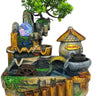 A decorative miniature fantasy waterfall fountain with a small tree, stone arches, a water wheel, a stone mill, a glowing orb, and a thatched-roof structure labeled 'Welcome'