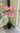 Pink artificial orchid plant in a pot indoors