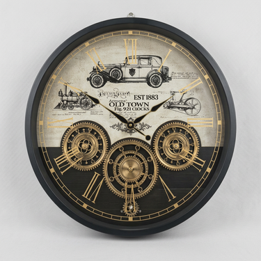 A round vintage-style wall clock with a black frame and a decorative dial featuring Roman numerals, gold-toned gears, antique car and train illustrations, and the text 'OLD TOWN EST. 1883'.