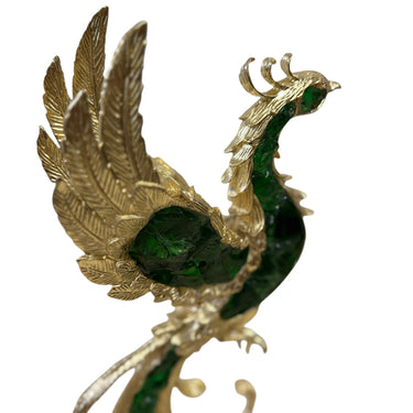 A decorative phoenix figurine crafted in gold-toned metal with deep green stone or enamel detailing in its wings and body, shown against a plain white background.